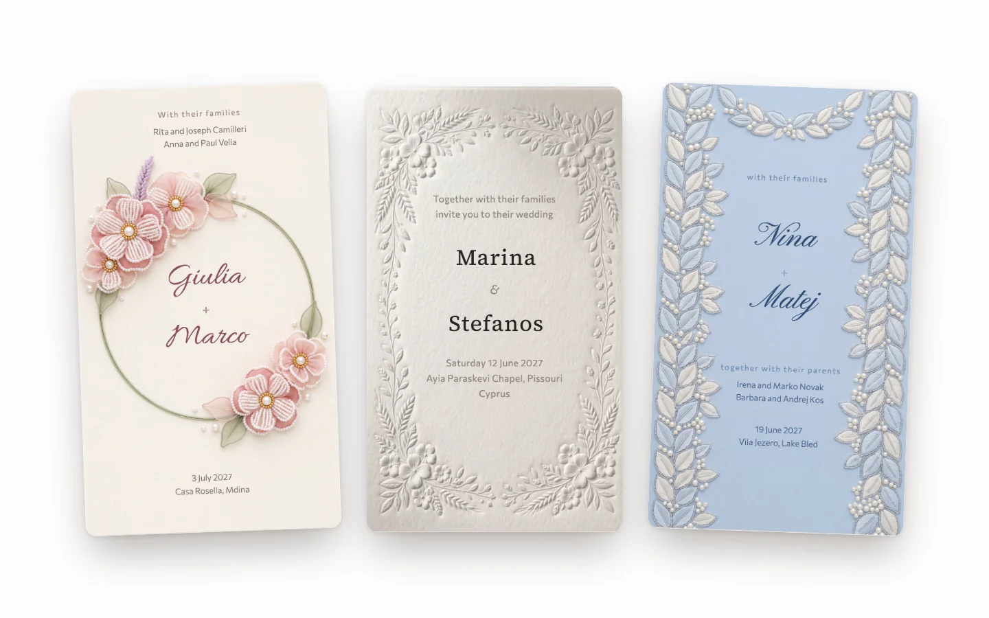 Three embroidered wedding invitations: pink flowers beaded in pearls, white Lefkara lace, and blue leaves and pearls on satin